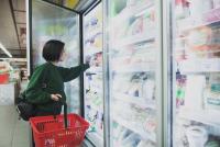 Image: shopper standing in front of supermarket coolers. Topic: Cool It for Climate